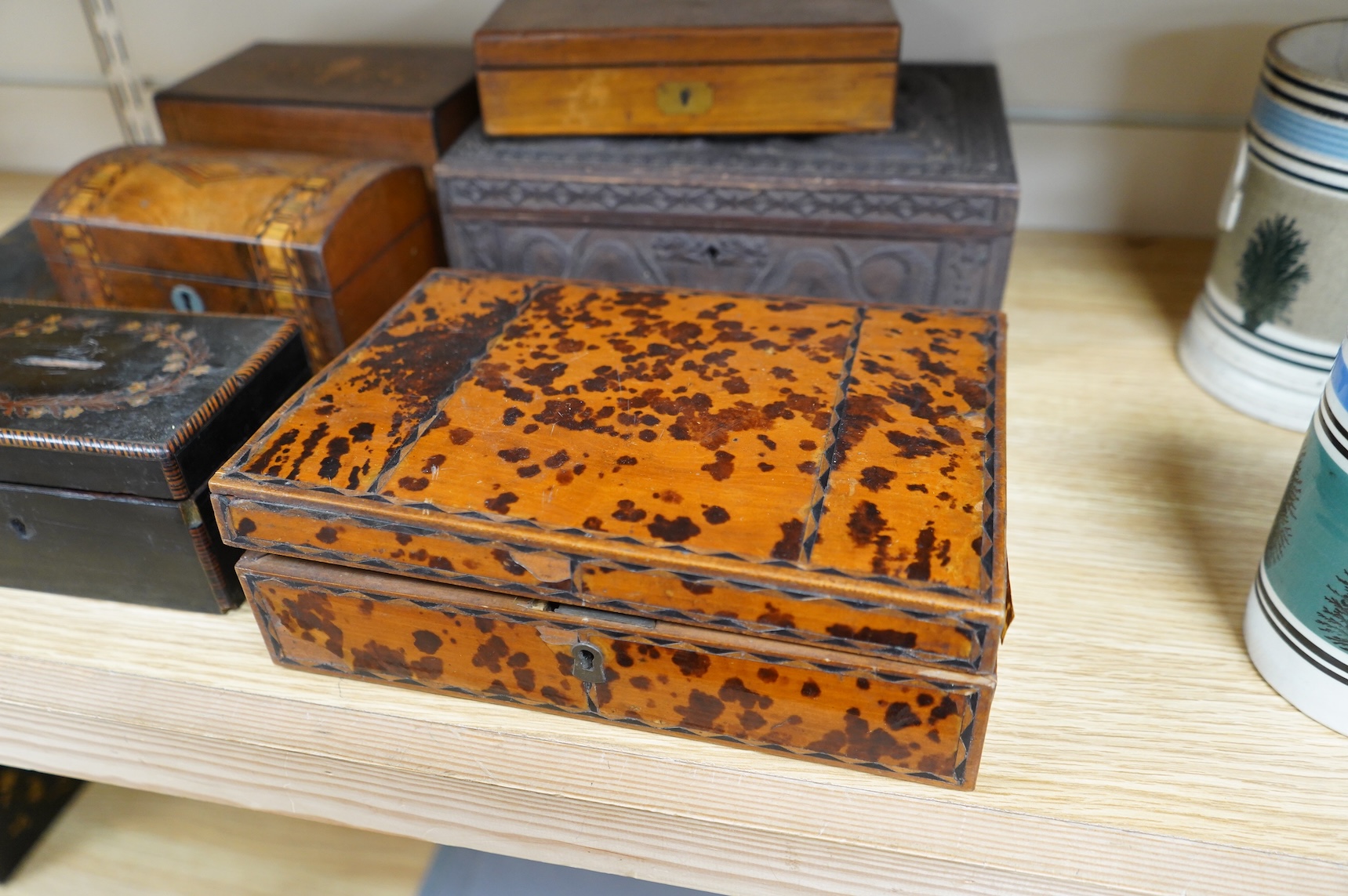 A blonde tortoiseshell veneered box, six other boxes and a miniature bagatelle board